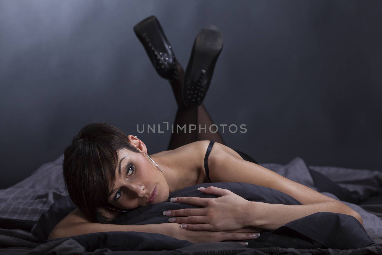 brunette woman lying in bed