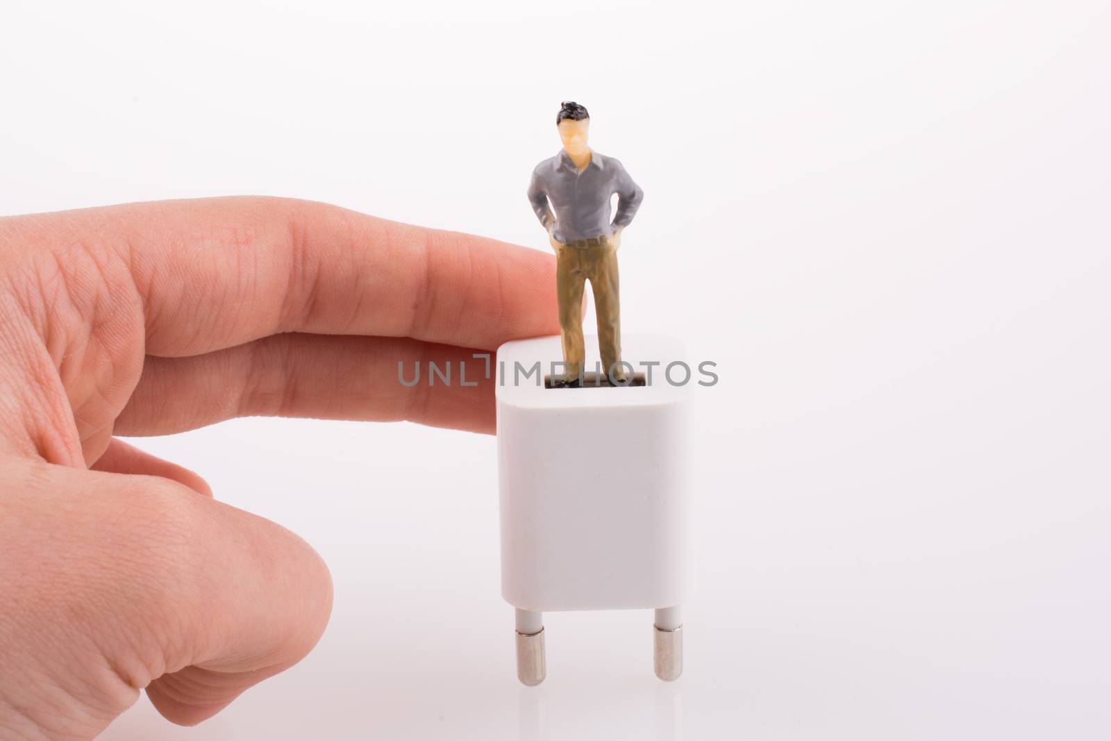 Hand holding a figure on an adapter by berkay