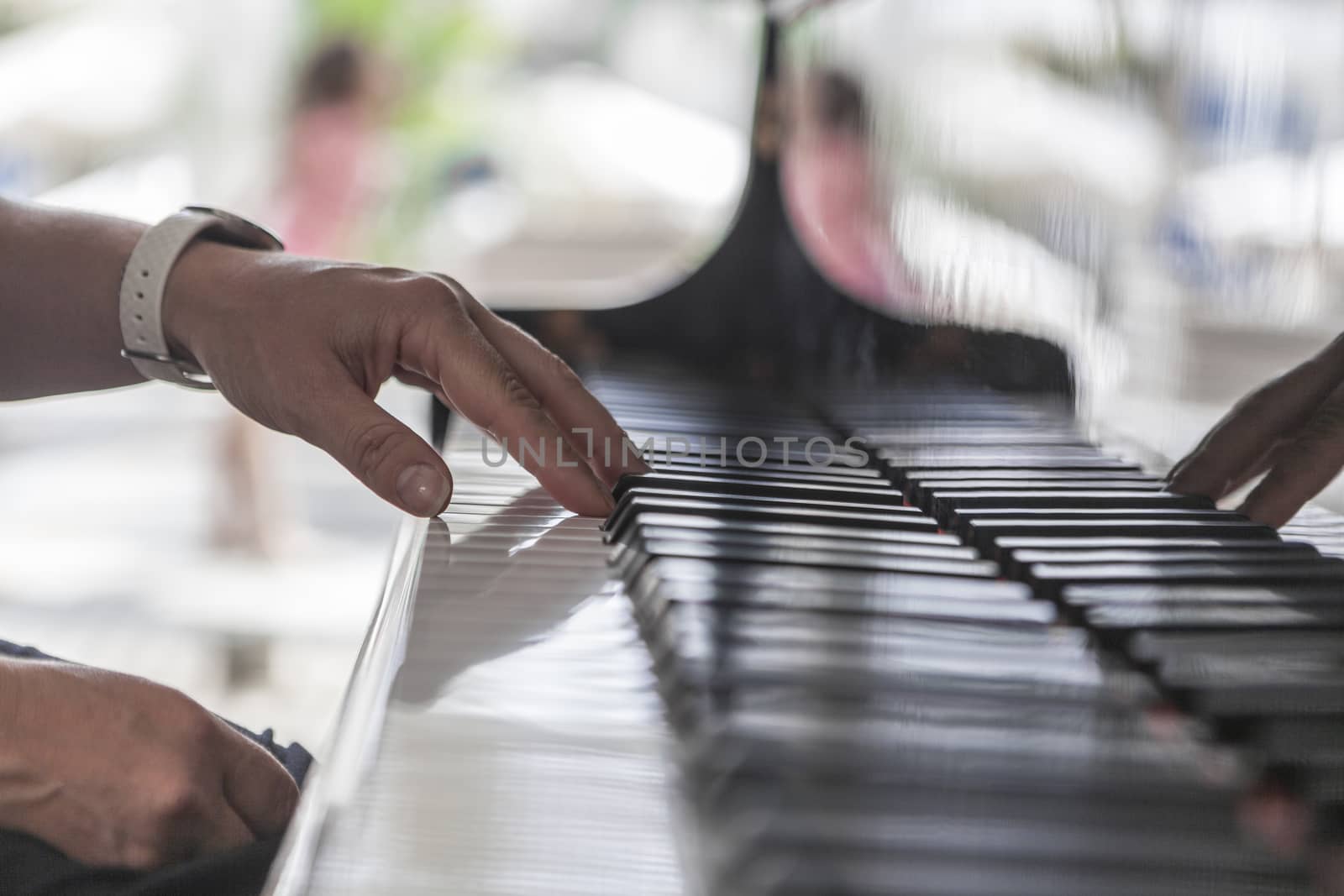 Beautiful picture of hand on a black piano