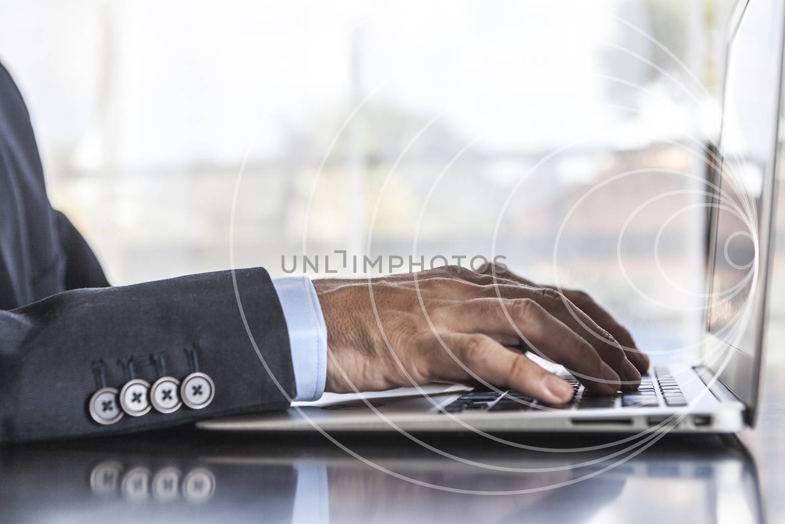 Man in suit using laptop in office
