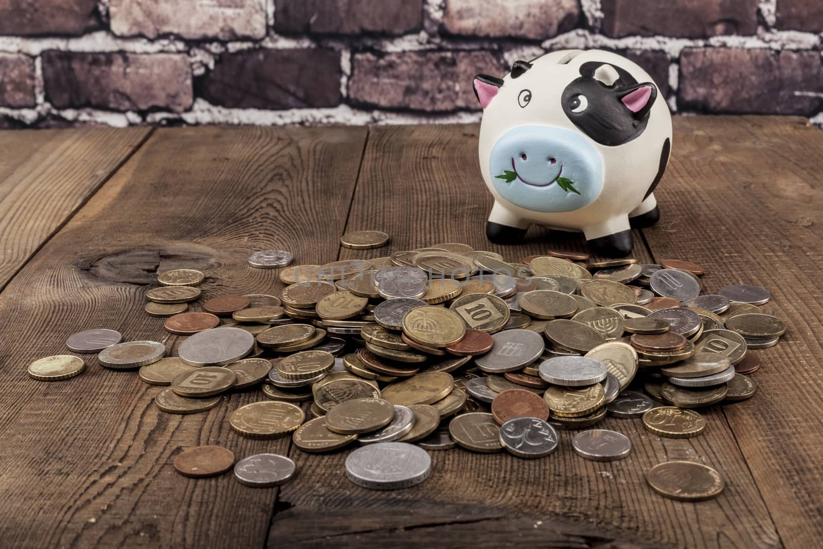 Piggy Bank on wood table and brick background