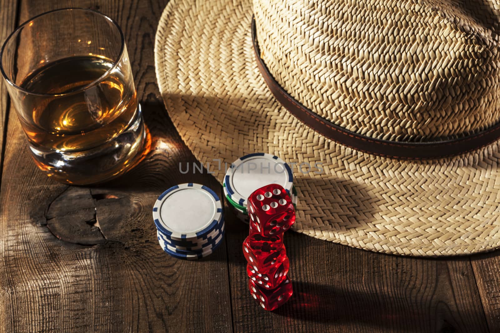 Alcohol and dice on brown wood table