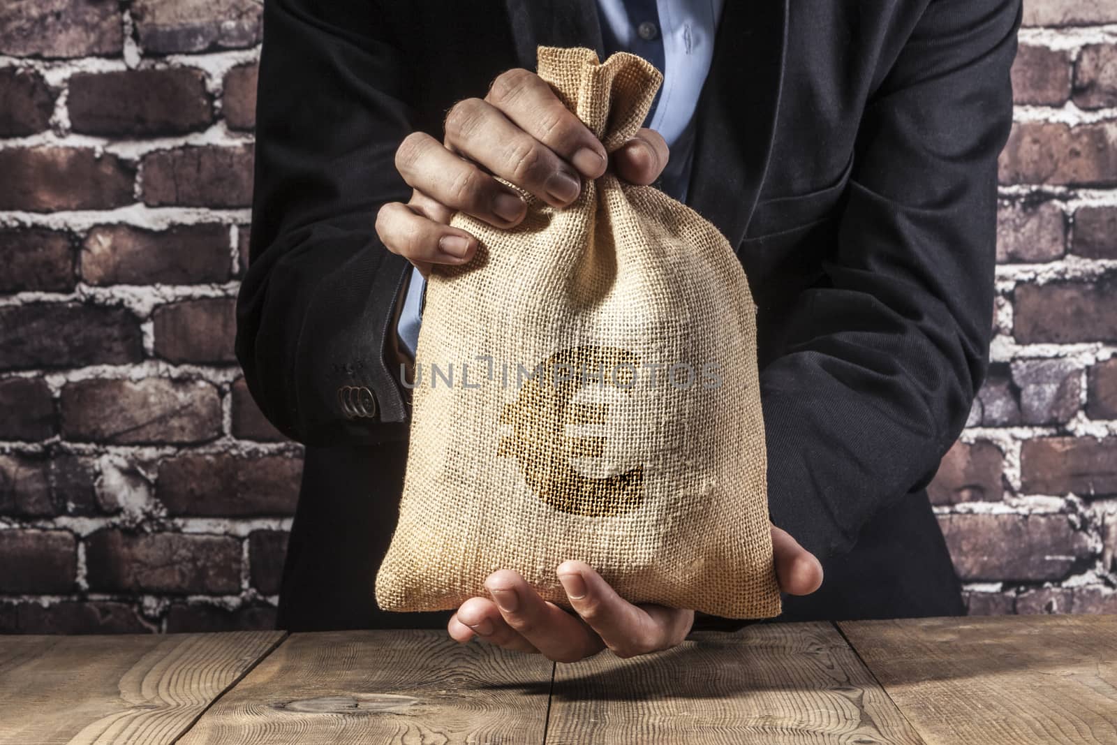 Man holding a big sack of money