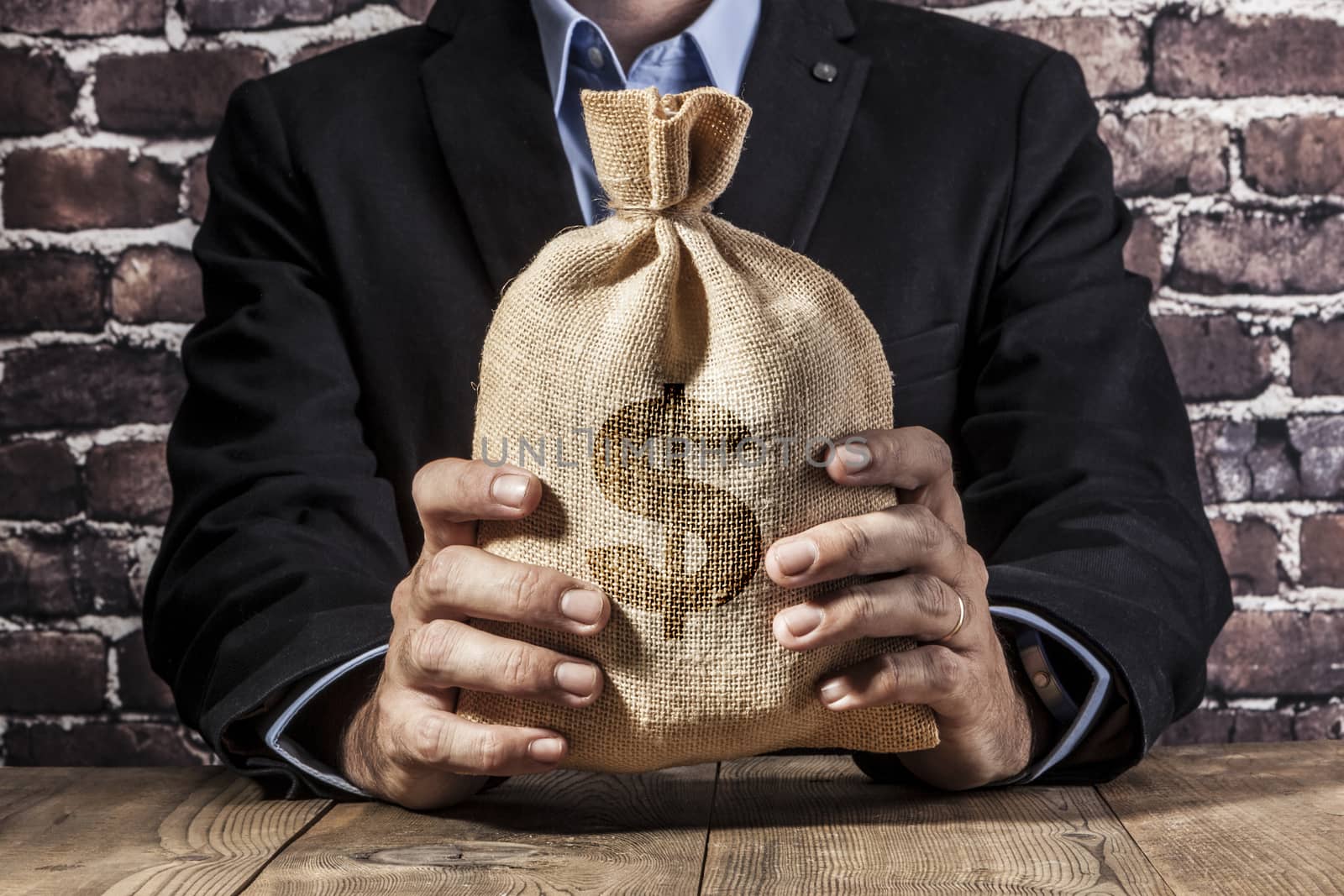 Man holding a big sack of money