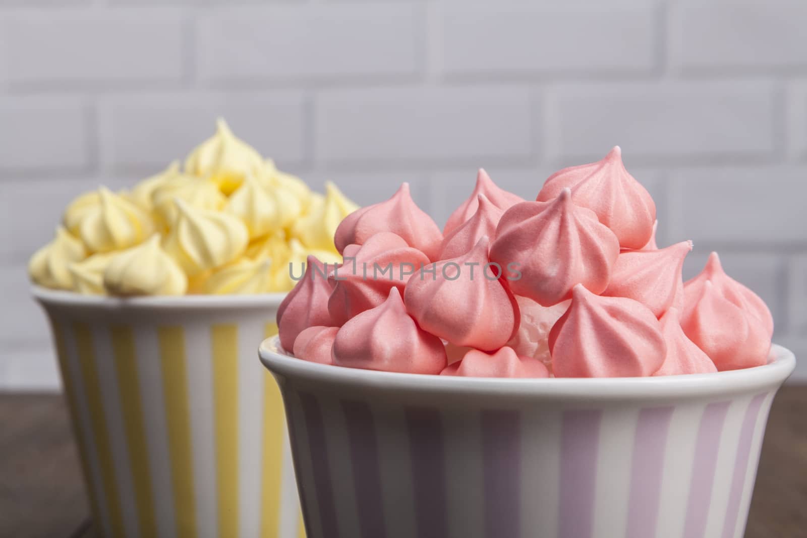 Sweets on wood table and white brick background