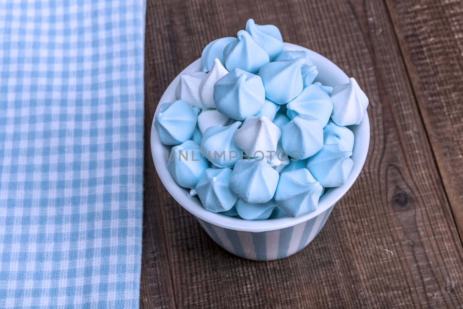 Blue Sweets in a cup on wood table