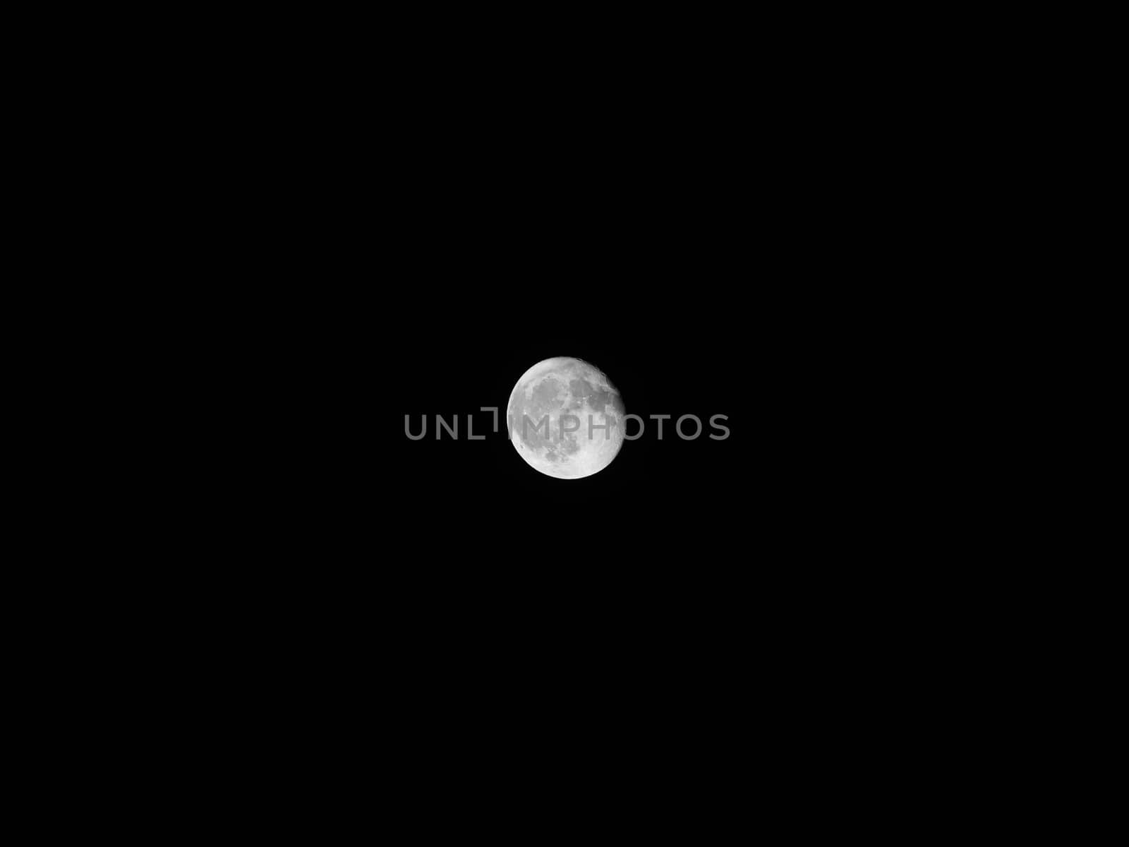 Big round circular sphere close up circle body of full white moon at dark night time clear sky on black background Seen through telescope. Planet universe astronomical galaxy space exploration concept