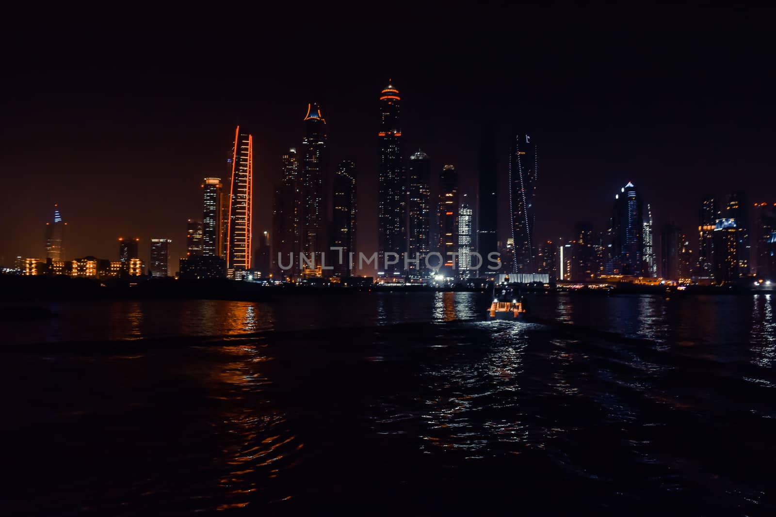 DUBAI, UNITED ARAB EMIRATES - UAE - Asia 23 APRIL 2016: Skyscrapers of City Marina at night. Panoramic skyline view lights and reflections. Famous for expensive property, high-end luxurious star hotel