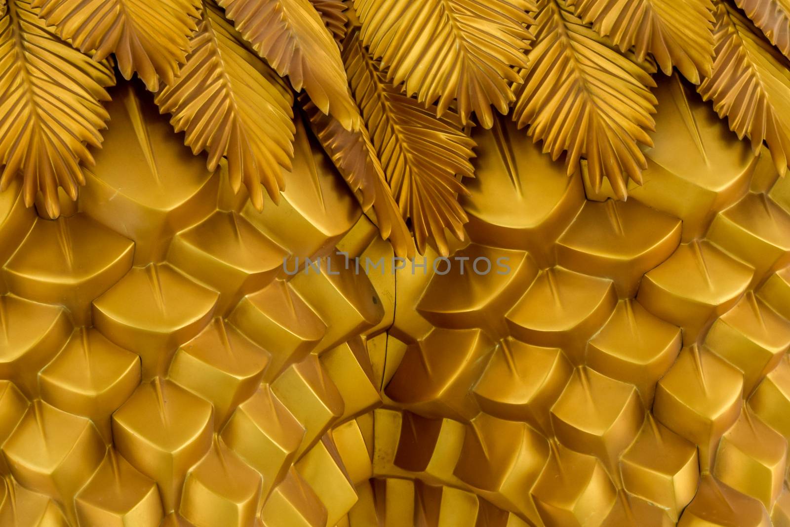 Abstract seamless geometrical wavy background from golden metal shaped and banners with ethnic patterns. Art decor wallpaper style of the tropics. Palm leaves of tropical plant creative composition