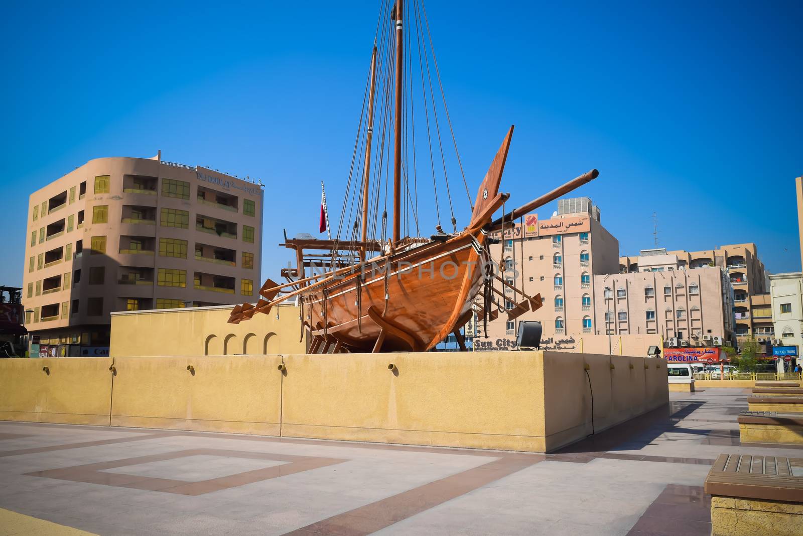 Old wooden heritage ship boat antique called a Dhow outside the Dubai museum in UAE ( united arab emirates)