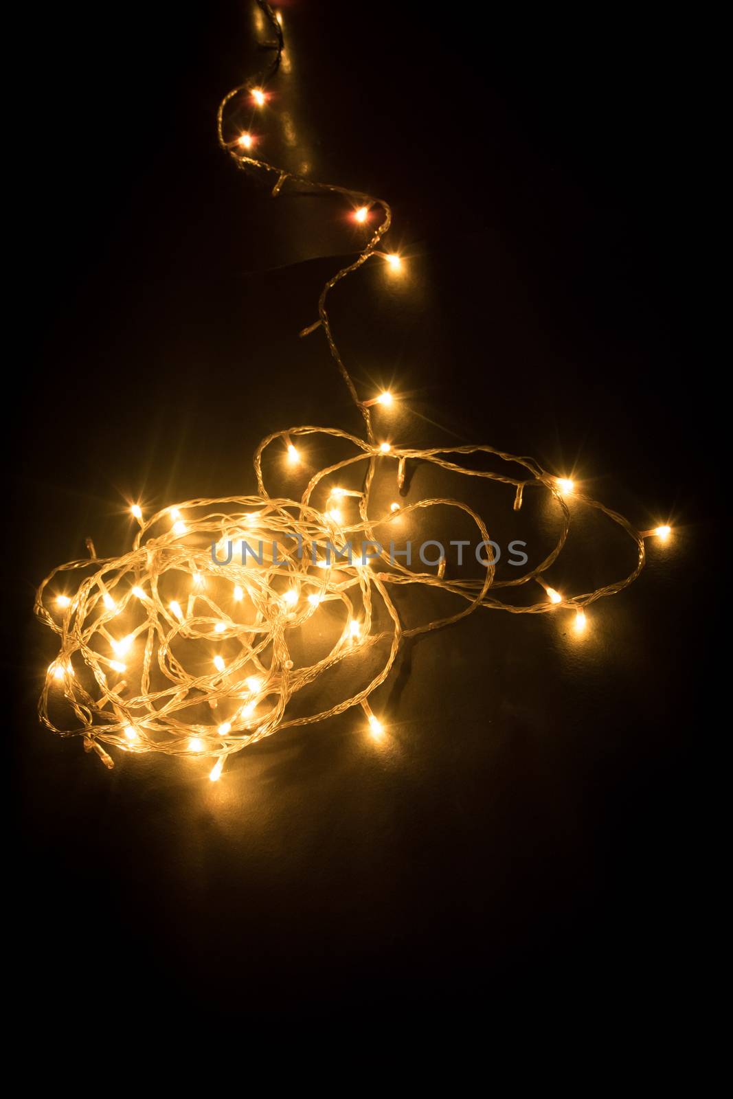 spiral shape design, decorate fireworks, chain light on dark black background shot in new years eve carnival with copy space.