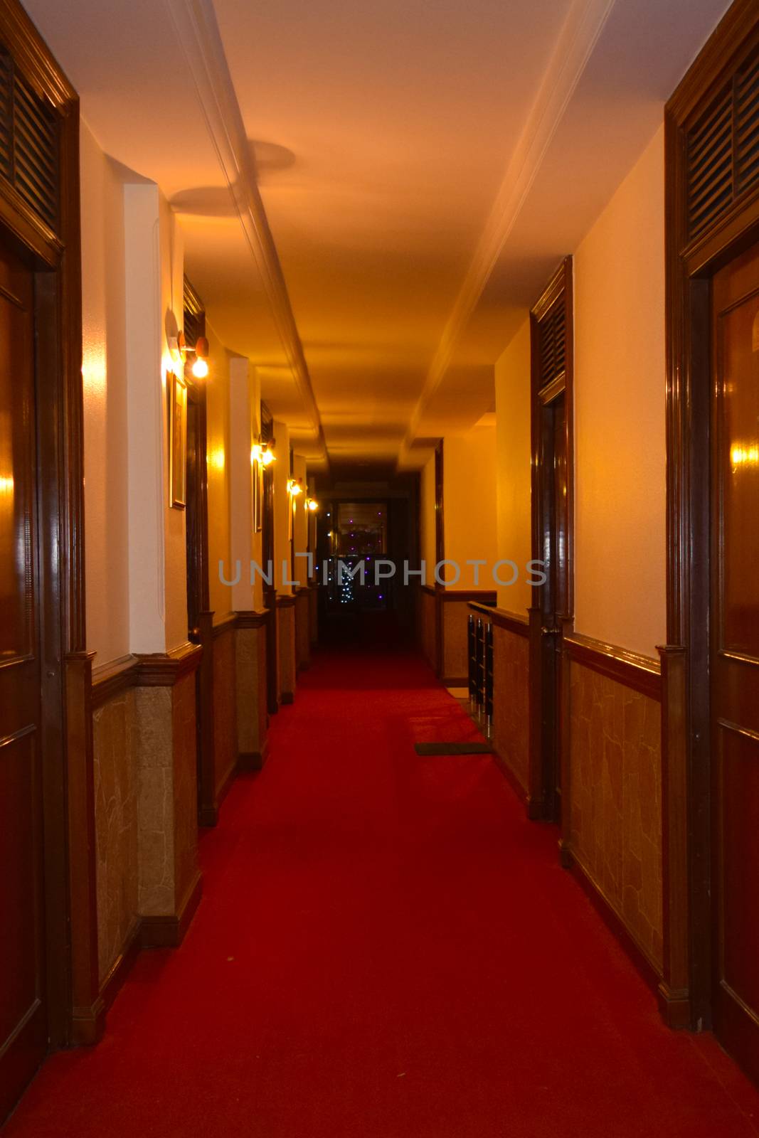 Center passageway of a luxury elegance polished quite corporate lounge lobby of a long big hotel with bright walls and illuminated lights. modern office conference hall style