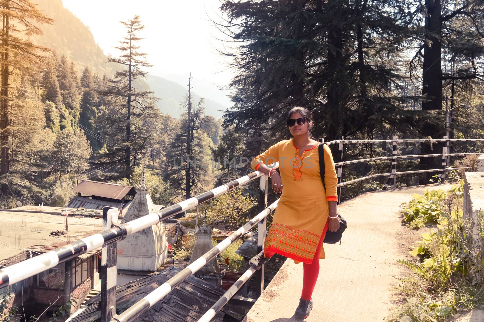 A woman standing in the heart of Manali City, Himachal Pradesh, Kullu, India. It is a popular tourist destination in northern India.