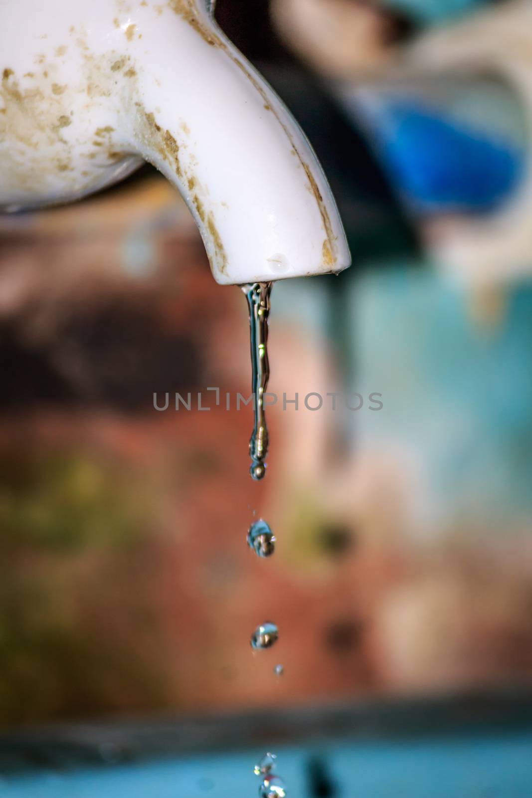 Fresh water leaking from old plastic pipe. by sudiptabhowmick