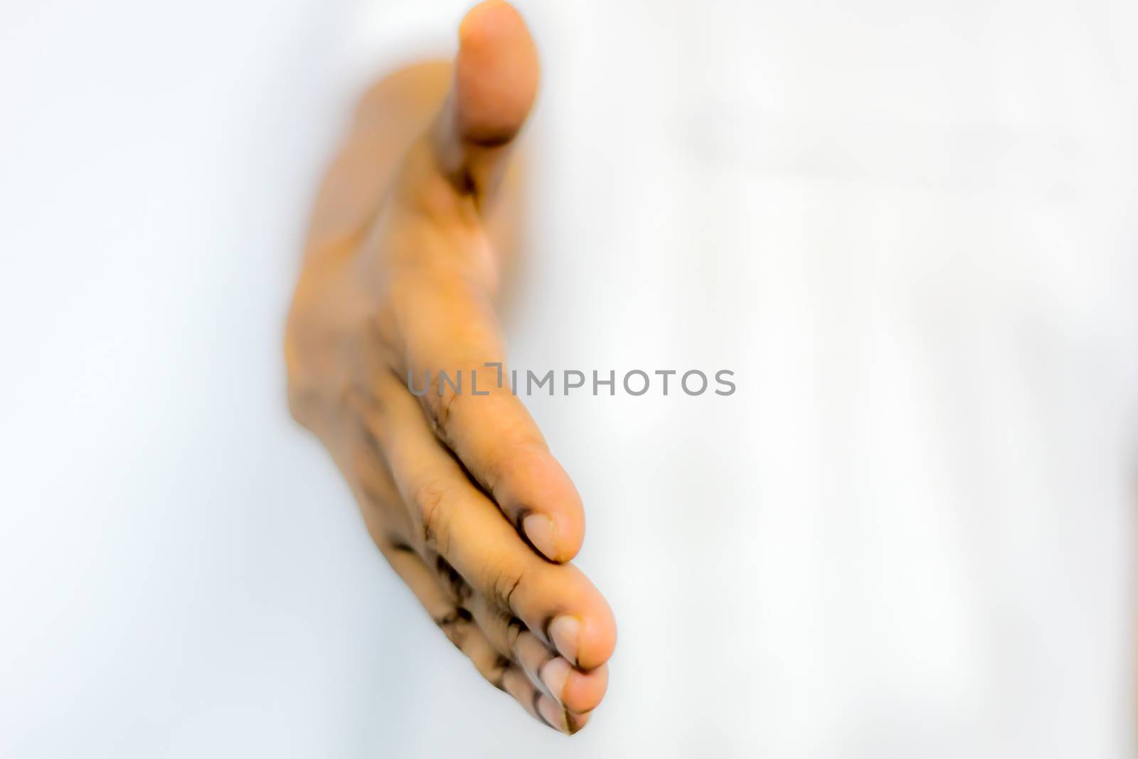 Close up businessmen hands stretched out for handshaking. Businessman or salesman, stretches his hand to conclude a business deal. Partners welcoming after negotiation of contract or agreement complete.