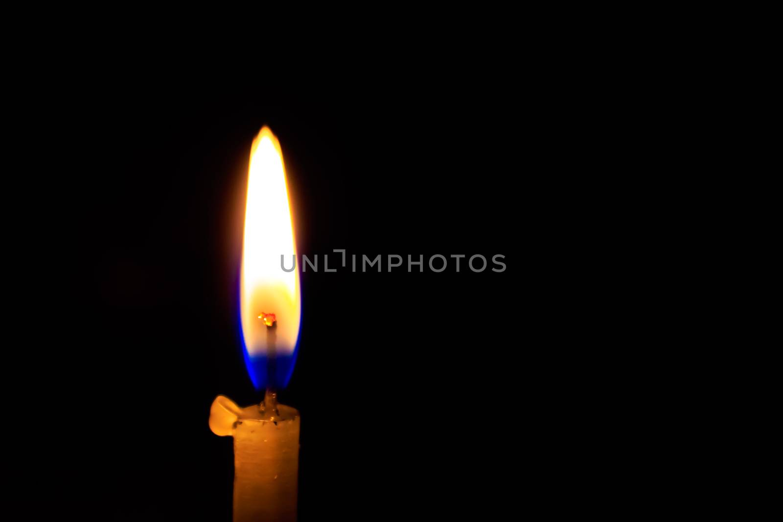 A burn or burning candle on black background, close up. Image taken in Diwali, a traditional celebration of Indian festival.