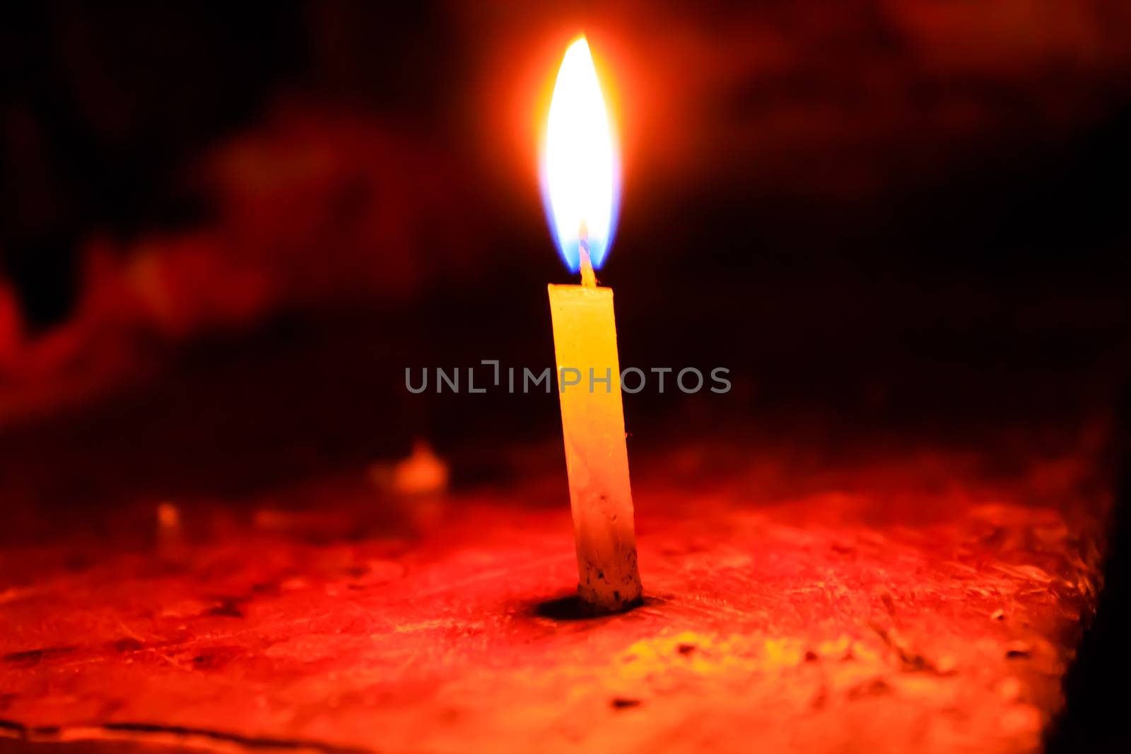 Candle spreading light isolated on blur background