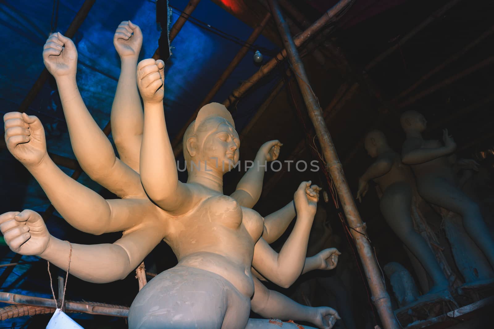 Handmade clay model of "Maa Durga" or " Devi Durga"- Hindu woman Idol close up. Snapped in the beginning of city famous Bengali festival of Kolkata or Calcutta, West Bengal, India, Asia