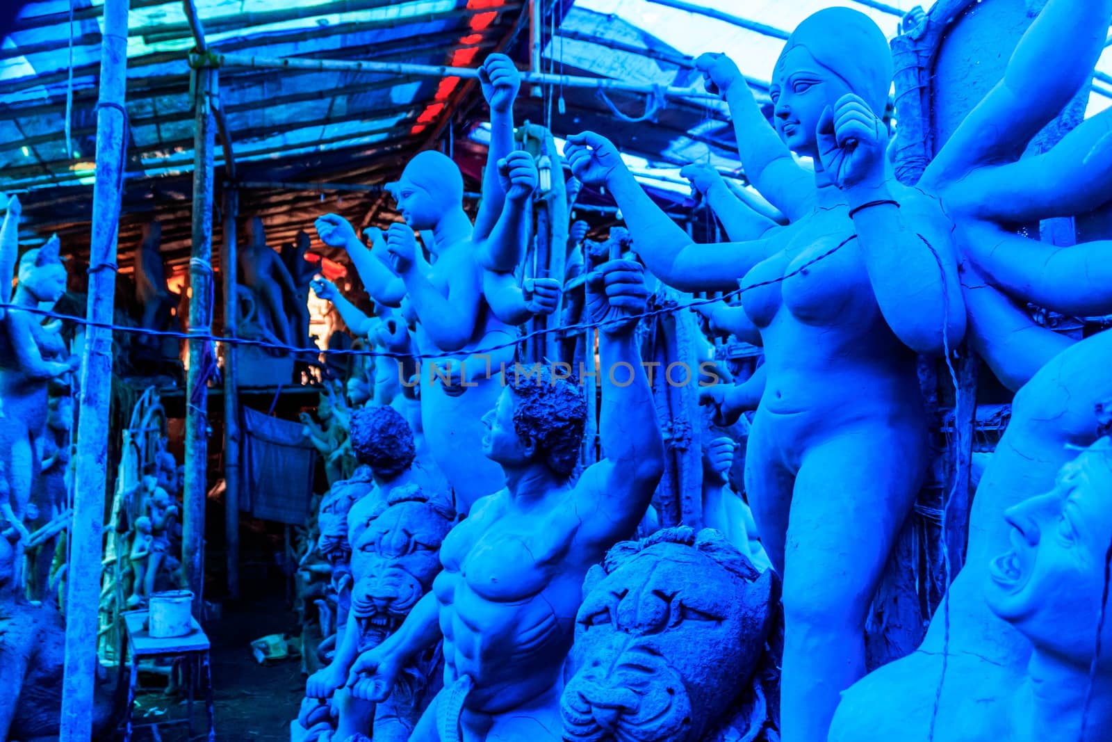 Handmade clay model of "Maa Durga" or " Devi Durga"- Hindu woman Idol. Snapped in the beginning of city famous Bengali festival of Kolkata or Calcutta, West Bengal, India, Asia