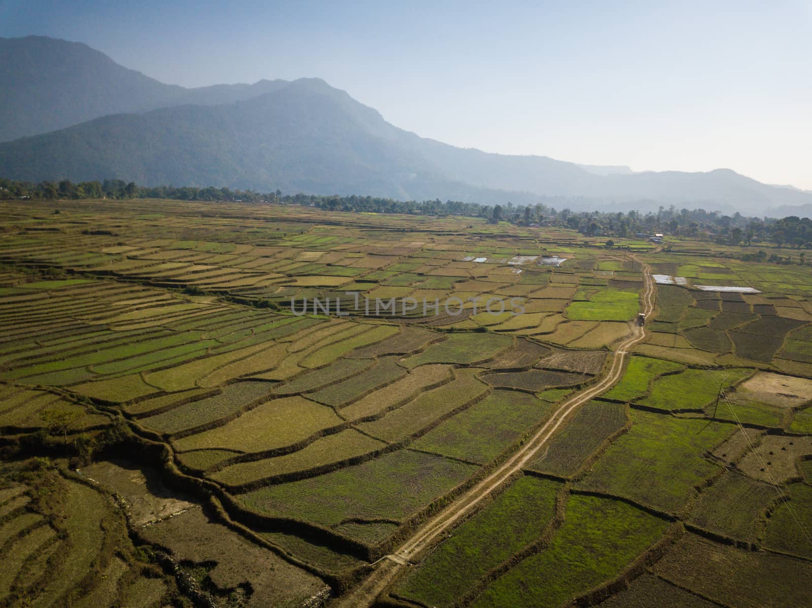 Aerial view of rural landscape in central Nepal. Paddy fields and hills in winter.