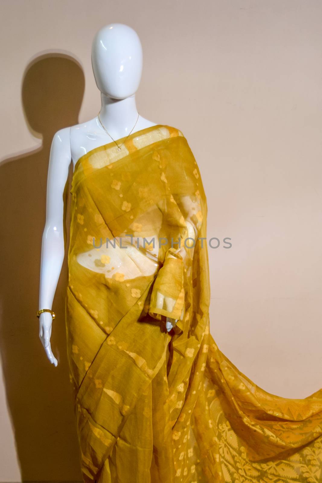 A traditional indian colorful silk saree displayed for sale. Selective focus on model face