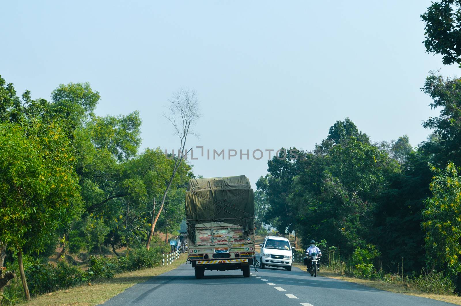 Semi Truck with Cargo Trailer Drives with container on highway, transportation concept. Truck is First in the Column of Heavy Vehicles. G T Road, Kolkata India.