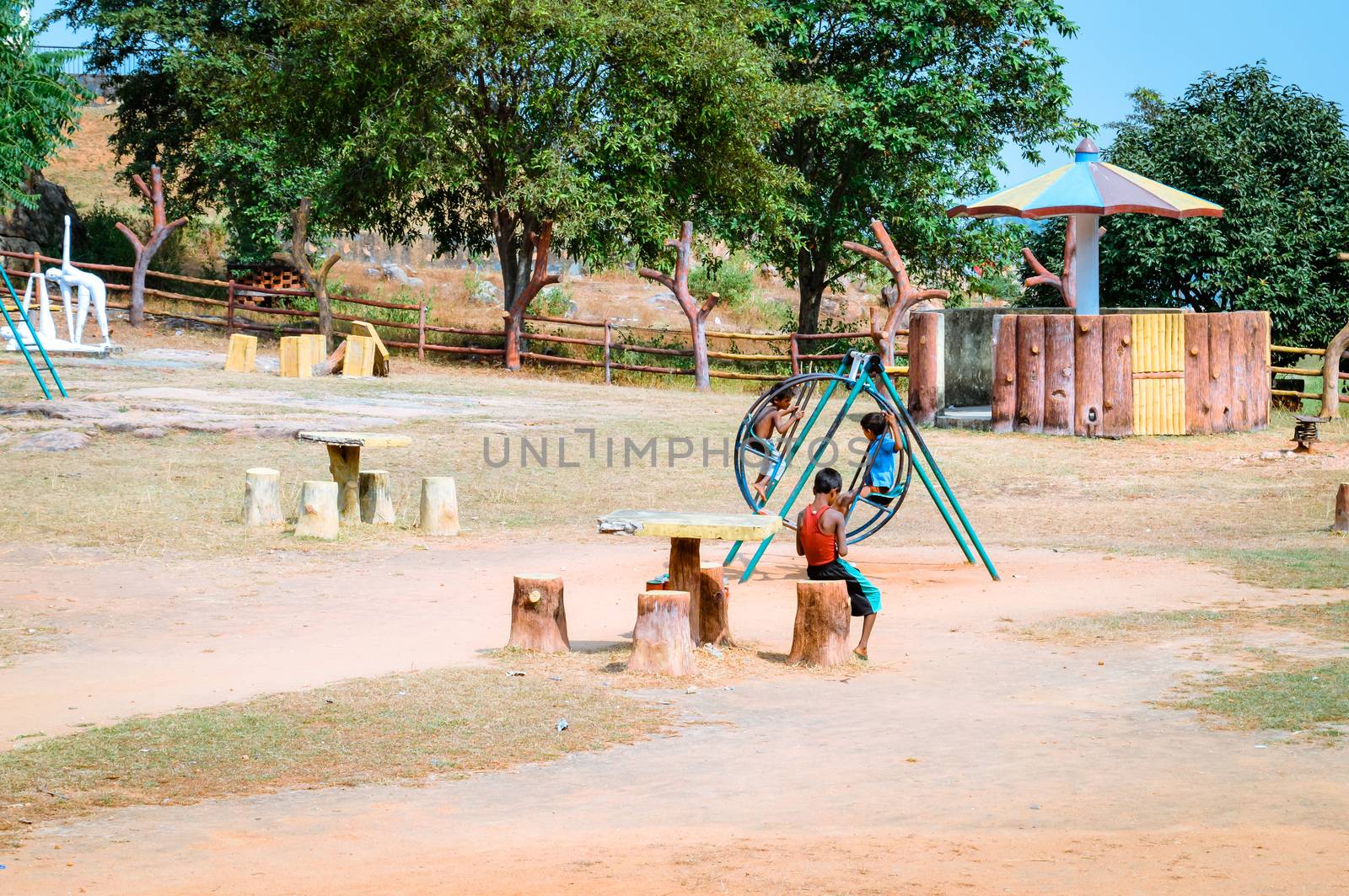 RANCHI, JHARKHAND, INDIA - MAY 14, 2017: Unidentified local little boys are playing in a village park. Jharhkand ethnic group of tribal village Children suffer of poverty due to bad economy.