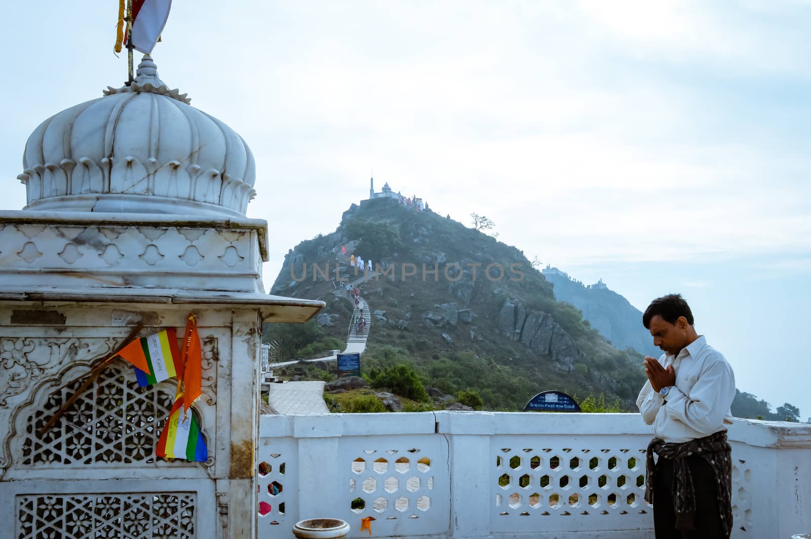MUKTAGIRI, MADHYA PRADESH, INDIA MAY 5 2016: A jain pilgrim devotee meditating in front of famous historical Jainism Temple. Muktagiri is a Jain Pilgrimage center and UNESCO World Herutage site.