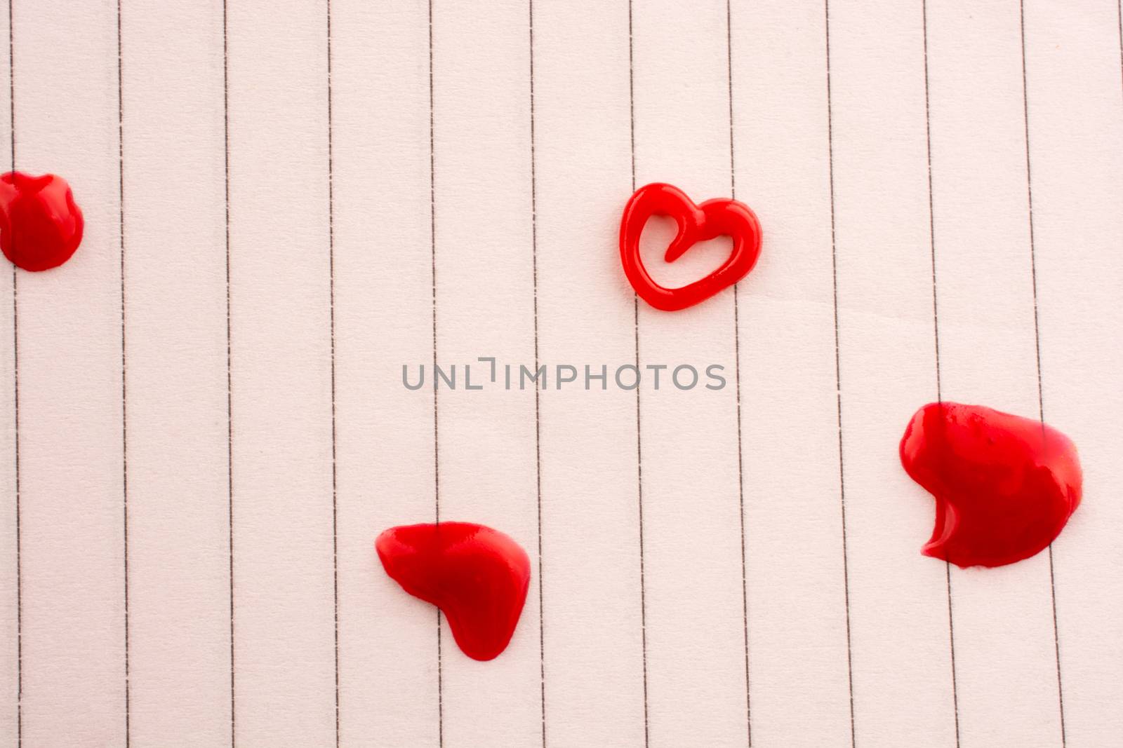 Heart shaped made by the help of a colored glue on white background