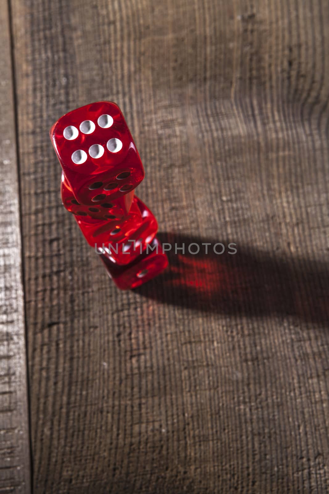 Red dice on a brown wood table