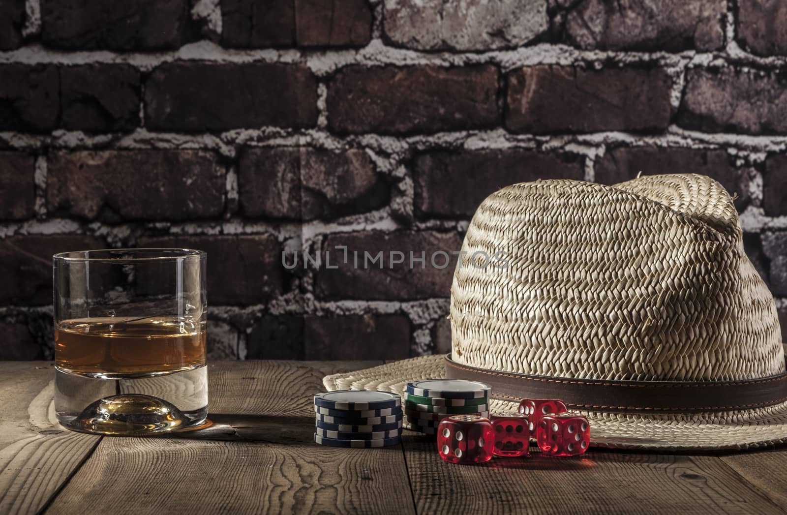 Hat, dice, chips and alcohol on wood table