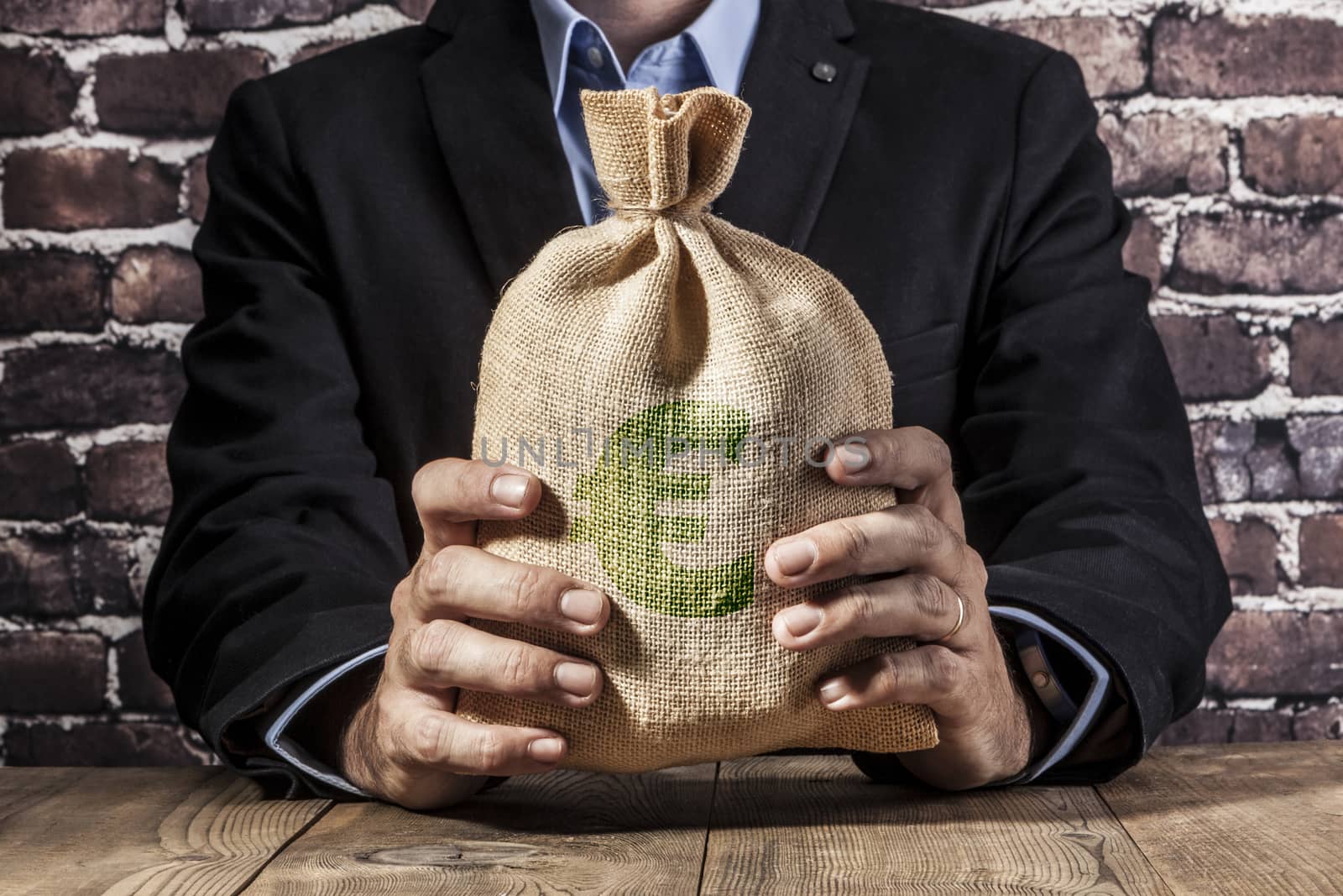 Man holding a big sack of money