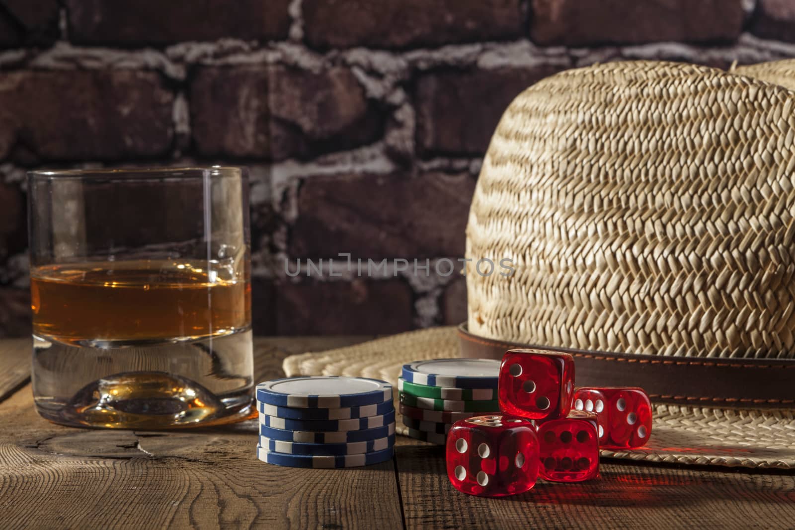 Hat and dice on brown wood table