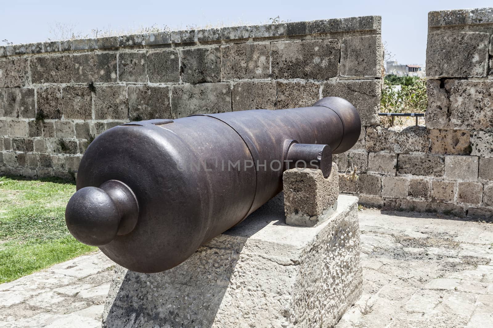 Big cannon on rock and old walls