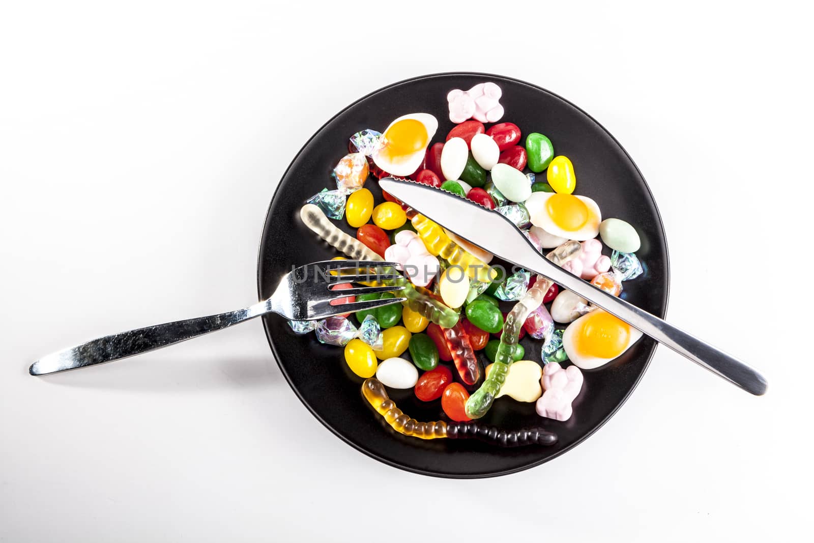 Sweets on plate isolated on white background with shadow