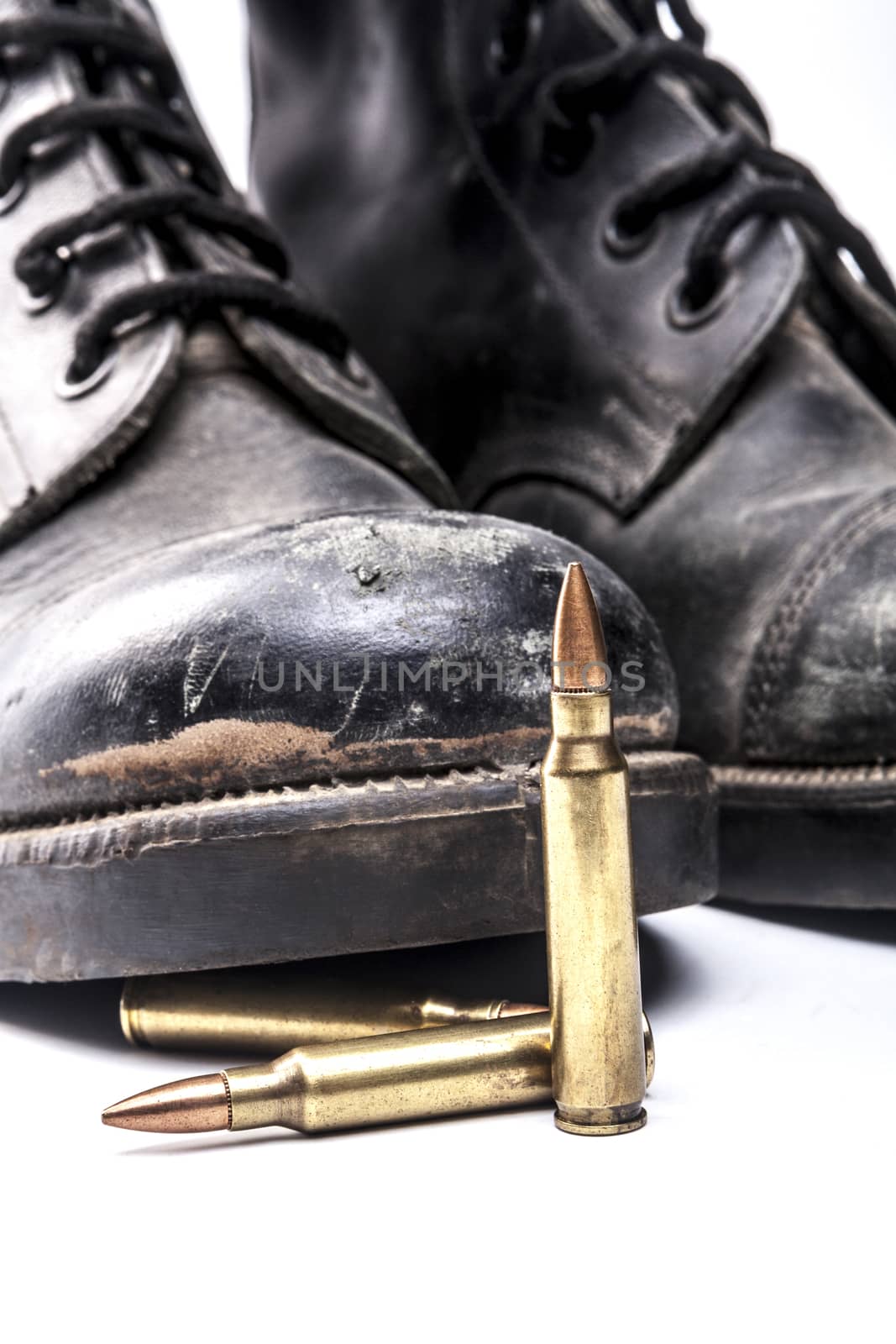 Bullets and army boots isolated on white background with shadow