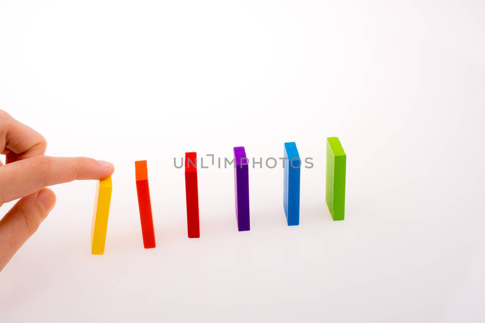 Hand playing with colored domino by berkay