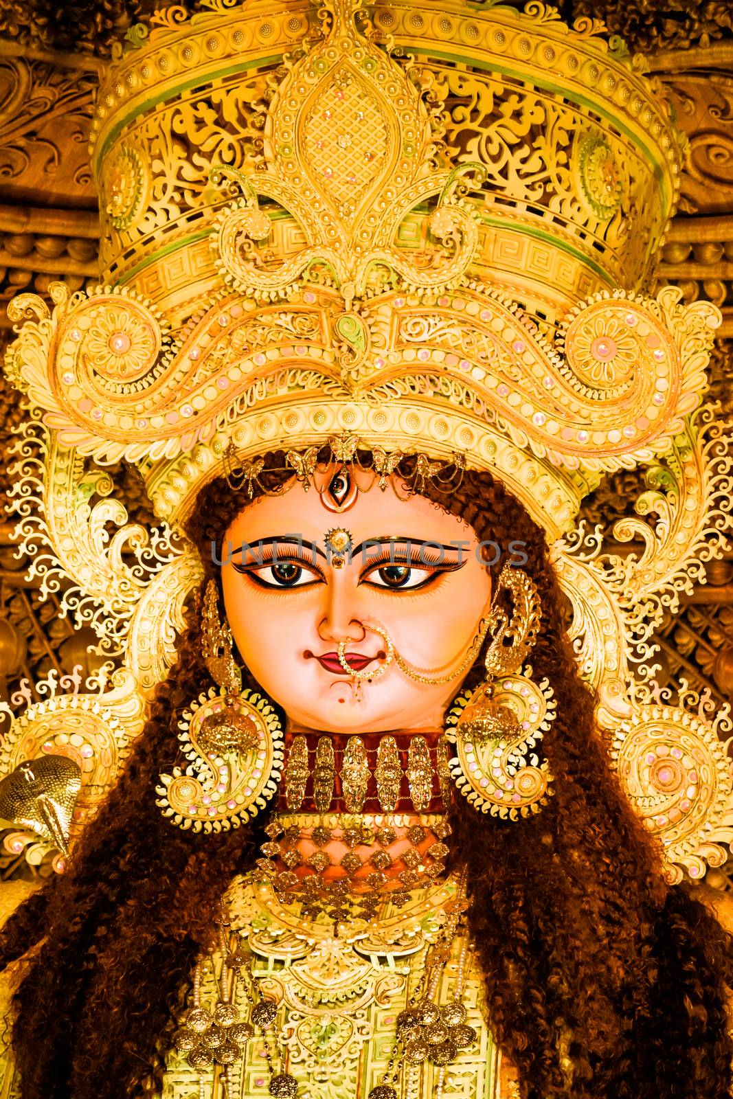 Chandannagar, West Bengal, India - November 16, 2018: Portrait of Hindu Goddess Jagadhatri Idol during Jagadhatri Puja celebration. Close up. Very well decorated goddess idol with heavy ornaments. by sudiptabhowmick