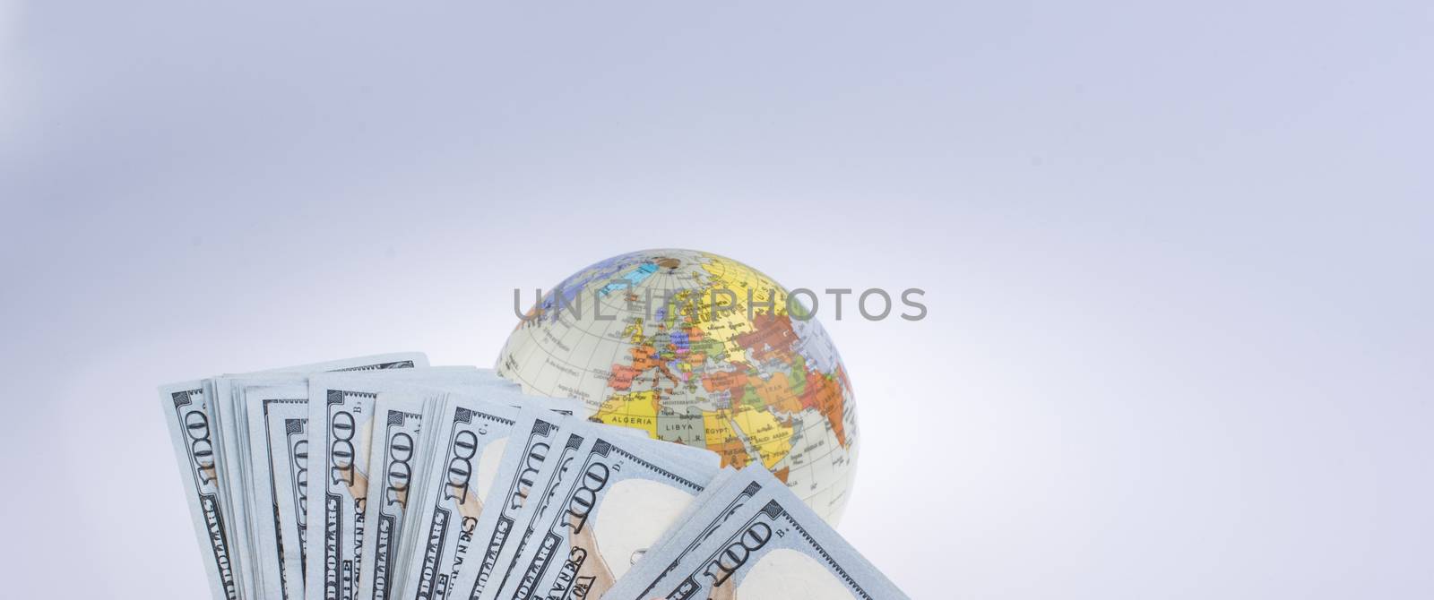 Human hand holding American dollar banknotes by the side of a mo by berkay