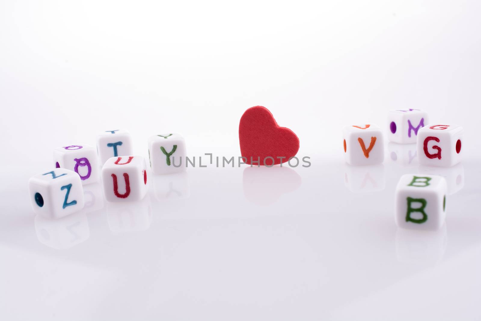 Heart between Letter cubes on a white background