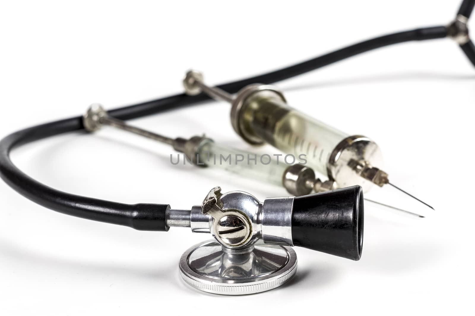 Glass Syringe With Black Old Stethoscope on White Background