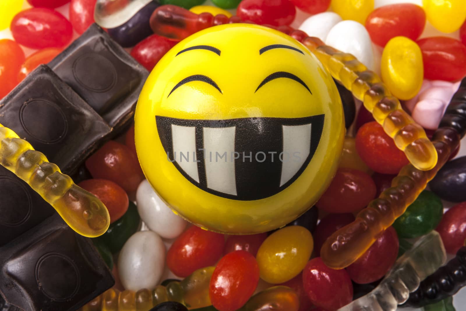 Happy emoticon and a lot of sweets