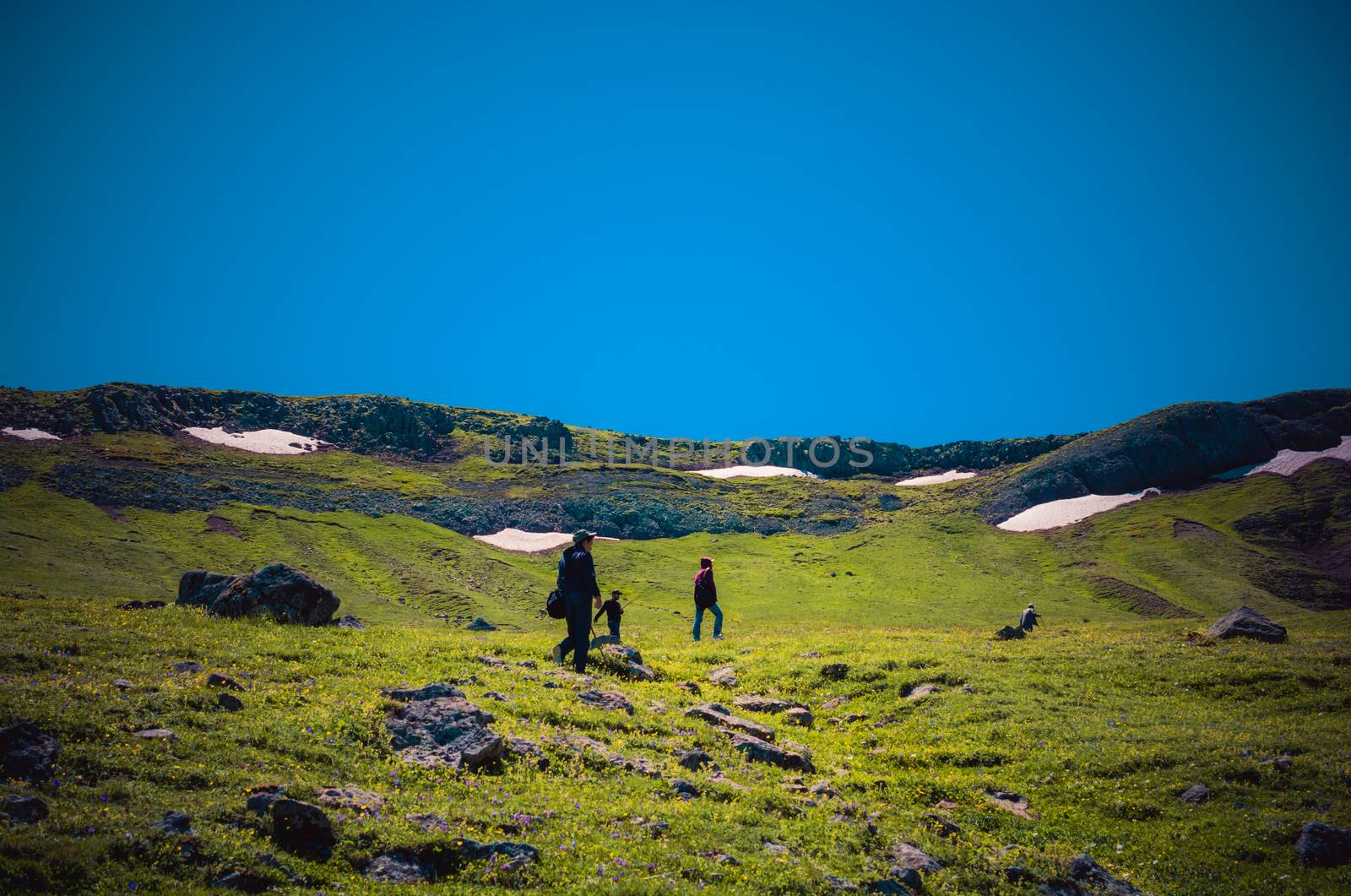 hikers with backpacks and trekking poles walking in Turkish highland