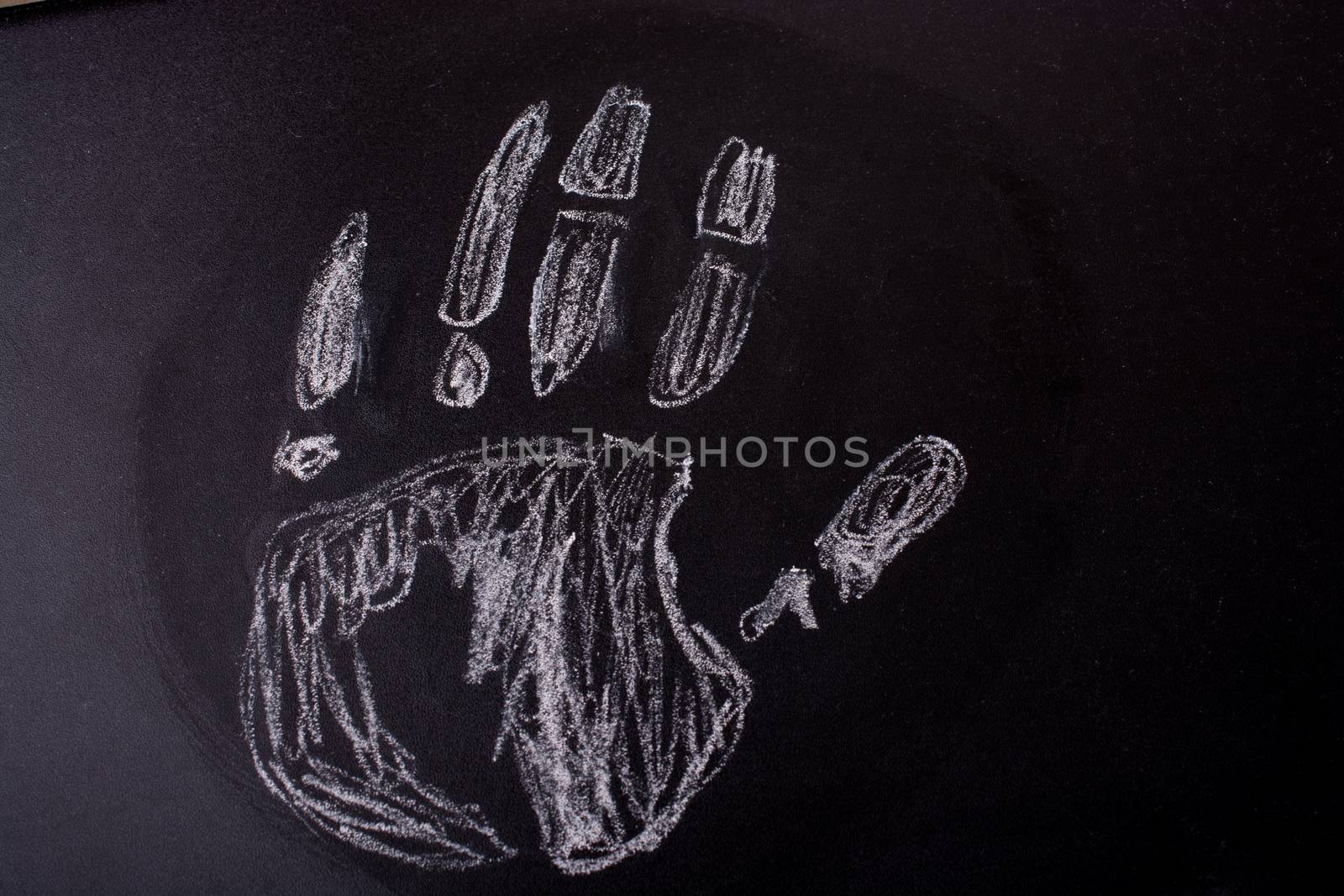 Handprint drawn by  white chalk on a blackboard