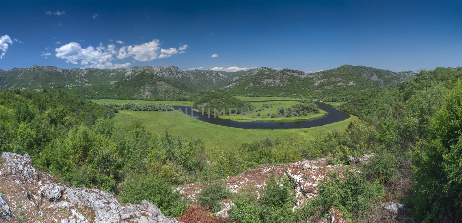 Panoramic view from above of Skadar lake and Crnojevica river in a national park, Montenegro, in a sunny summer day