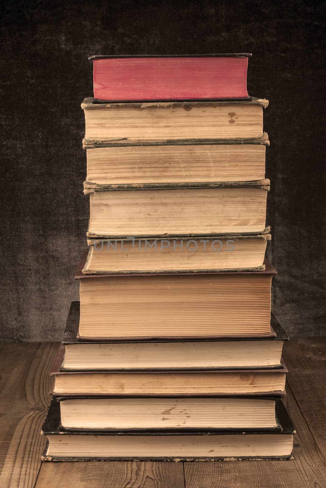 Old Books Pile on Wood Table with Dark Background