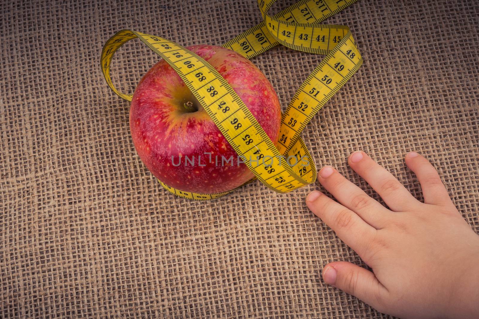 Red apple with a measurement  tape on it by berkay