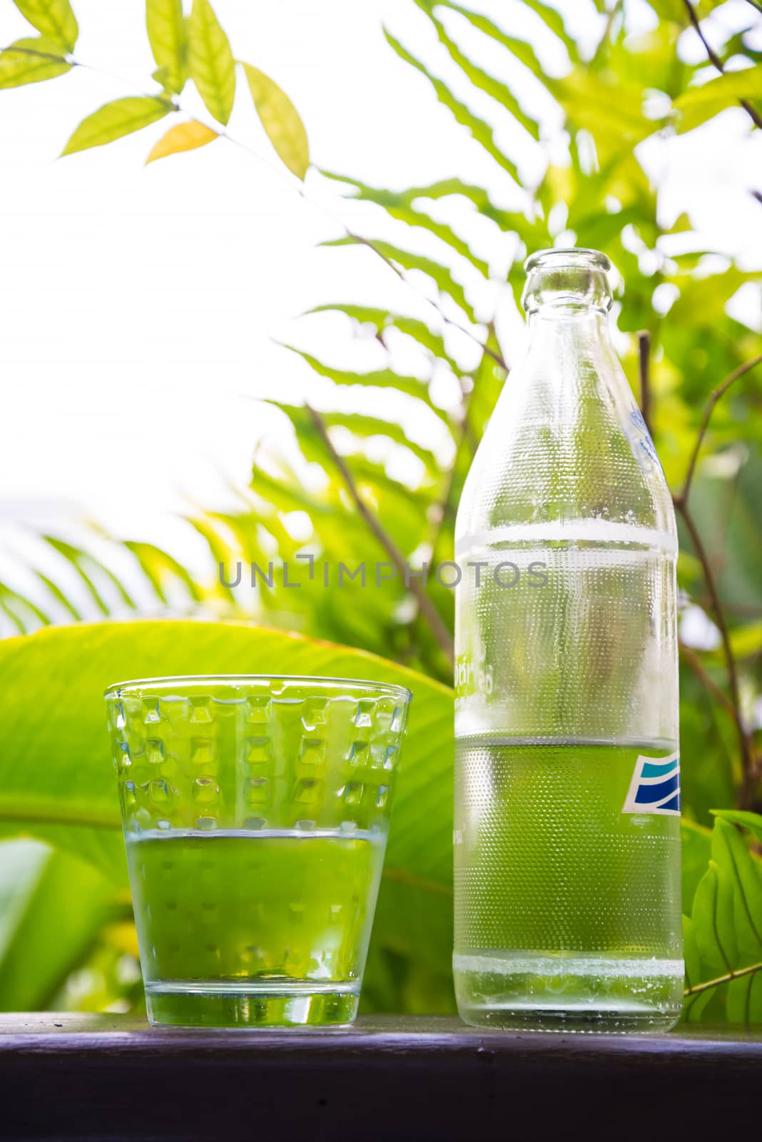 Glass of water, put on the balcony among the nature.