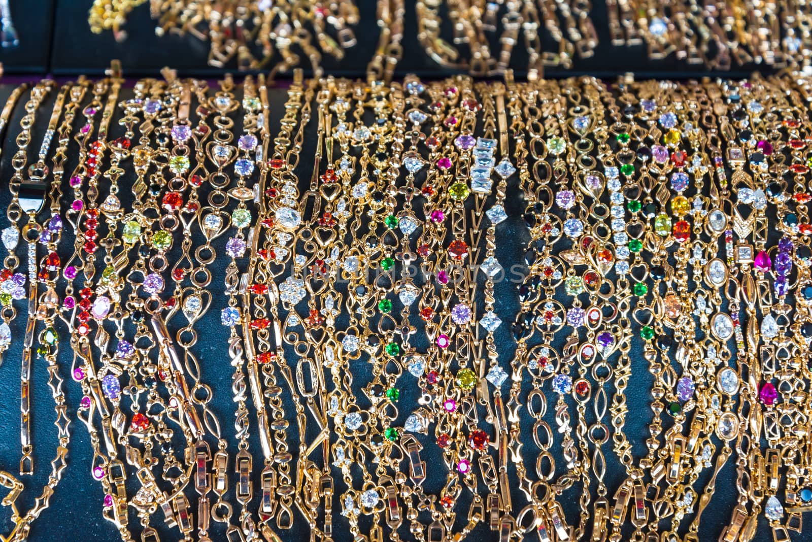 many jewelry on black background.