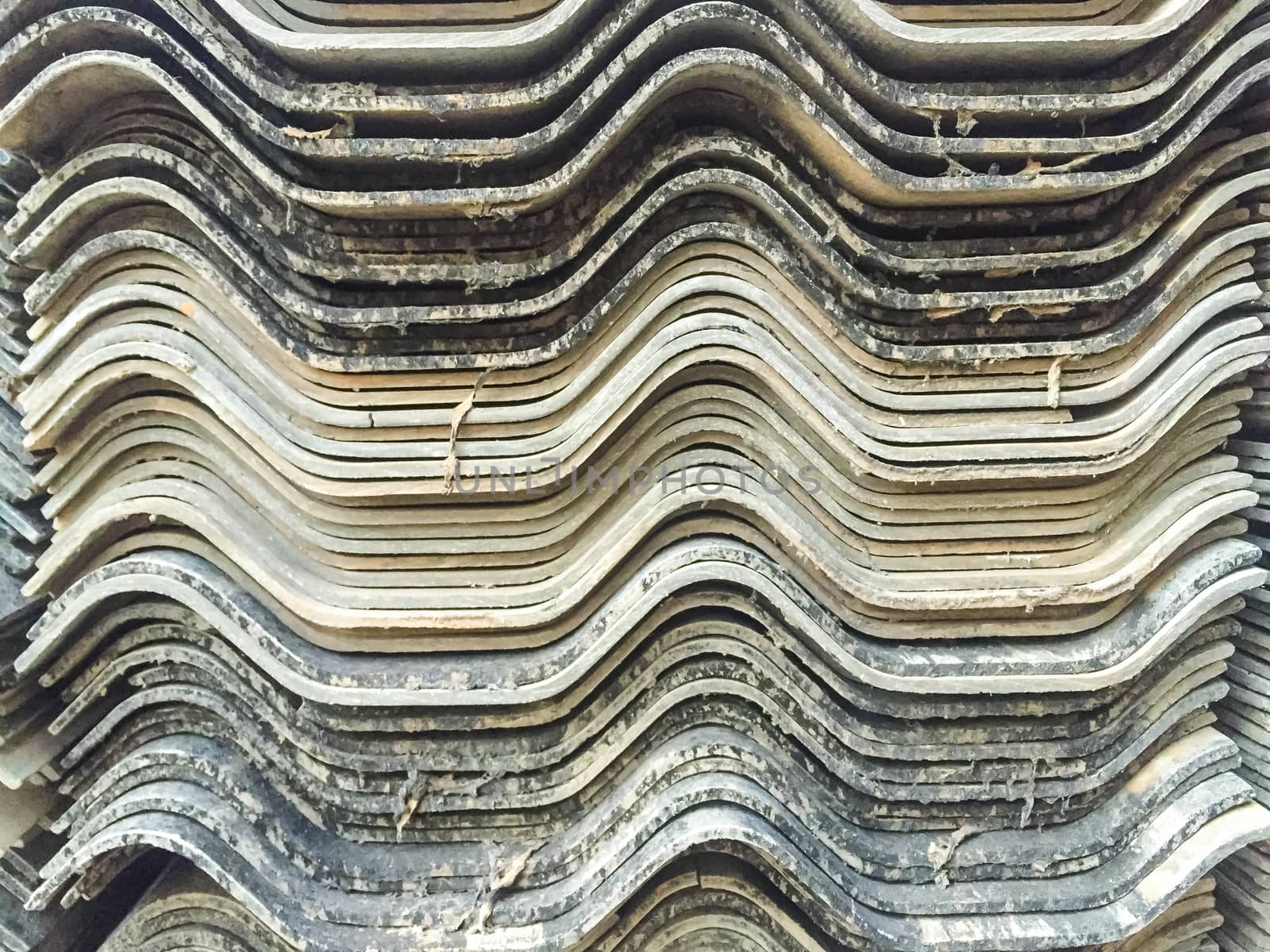 Stacks of old roof tiles, texture background.